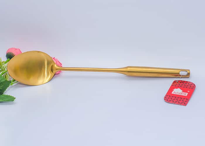 Gold cooking spoon